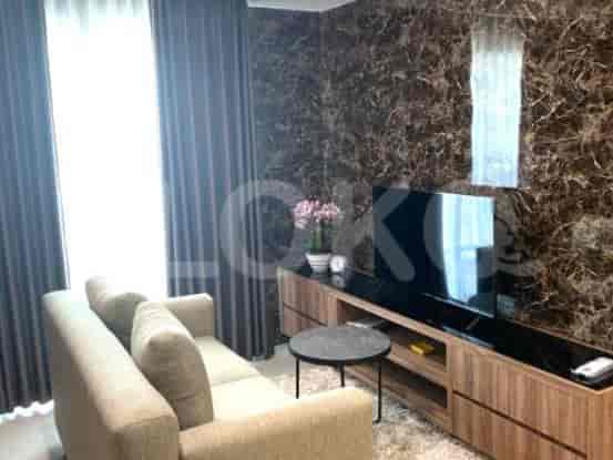 Living room with sofa, TV, and a marble accent wall.
