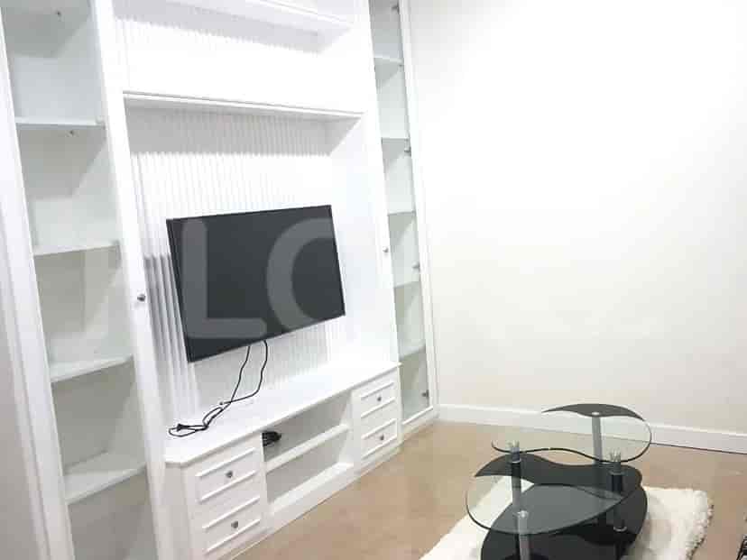 Living room with entertainment center and coffee table.