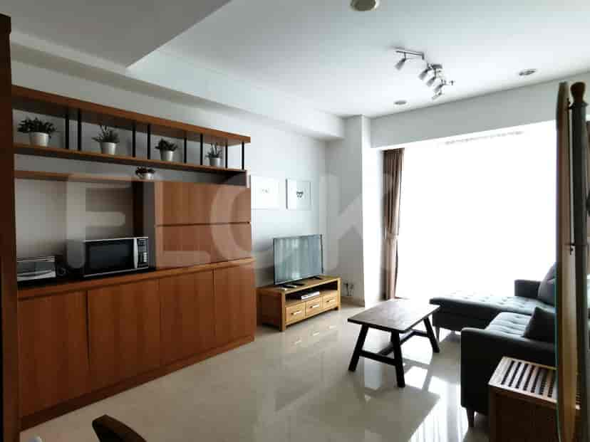 Living room with a wooden coffee table, TV, and a large window.