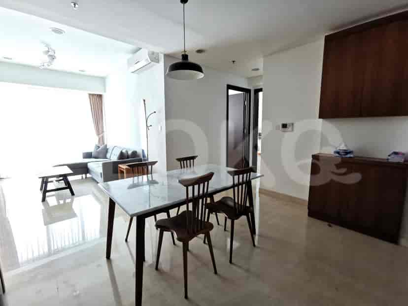 Dining area with a marble-top dining table and wooden chairs.