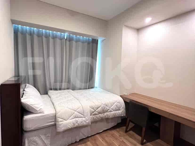 Kamar tidur dengan tempat tidur, meja, dan jendela berkorden.