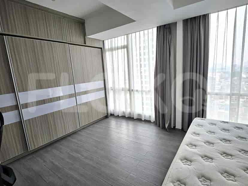 A bedroom with a bed and a large sliding closet.