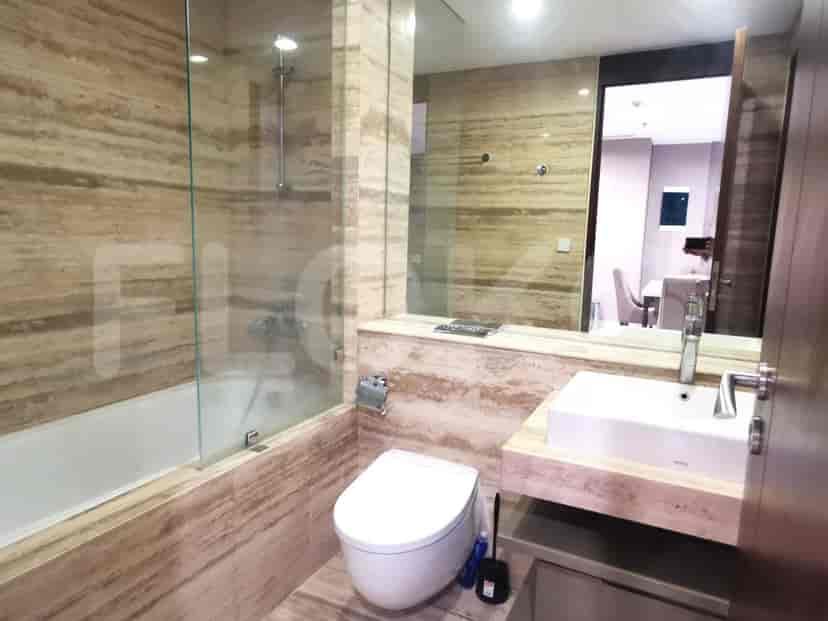 A well-appointed bathroom with a bathtub and shower, featuring elegant marble.
