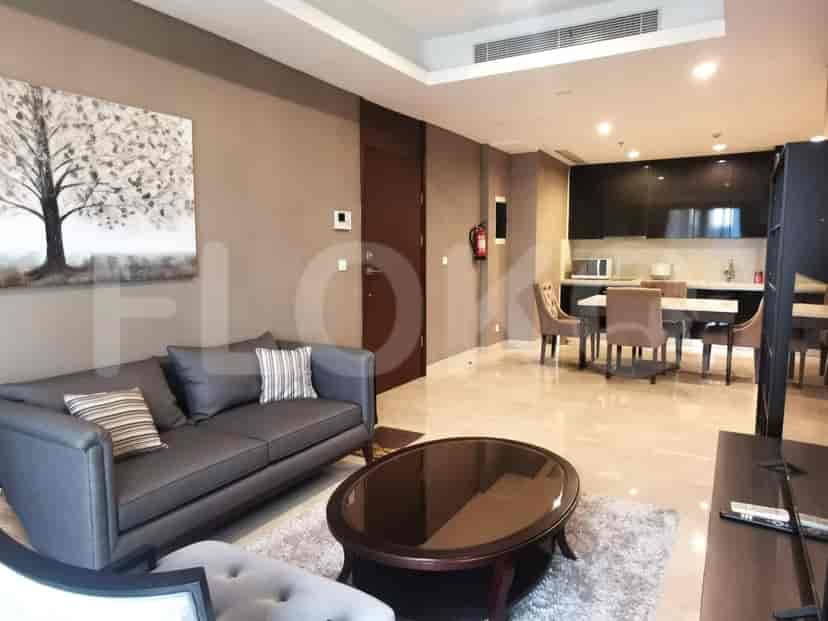 Spacious living room area showing the kitchen, dining, and seating areas with a modern aesthetic.