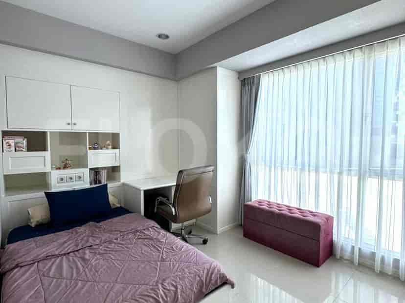 A guest room with a desk, chair, and a large window.