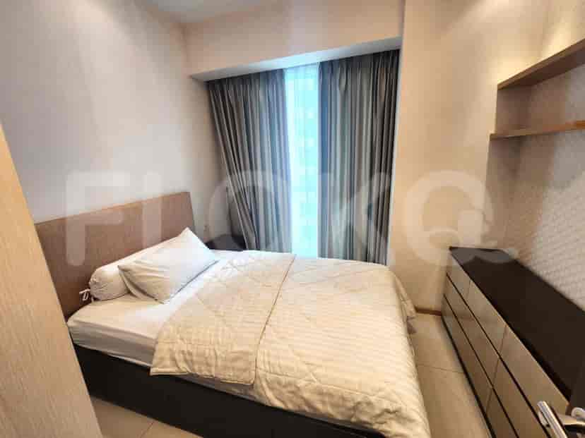A cozy bedroom featuring a bed, dresser, and curtains.