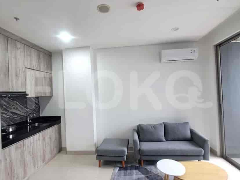Modern living area with kitchen and a small seating area.