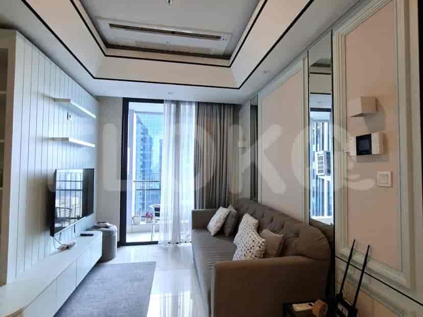 A living room featuring a sofa, large window, and a dining table.