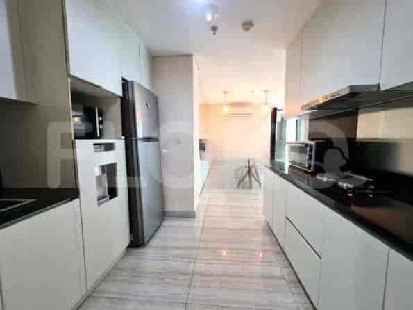 Modern kitchen with white cabinetry, stainless steel appliances, and a long design.