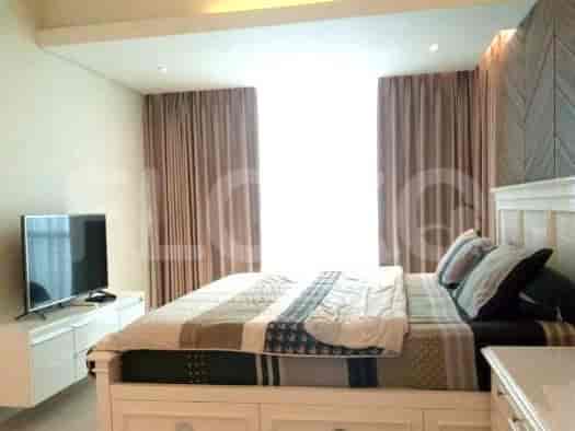 Bedroom with a bed and a TV.