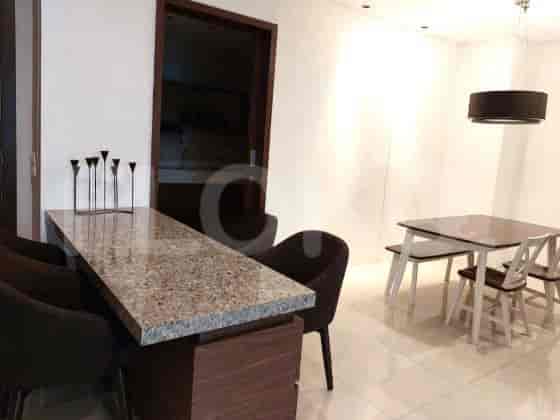 Dining area with a granite-topped breakfast bar and a separate dining table with chairs.