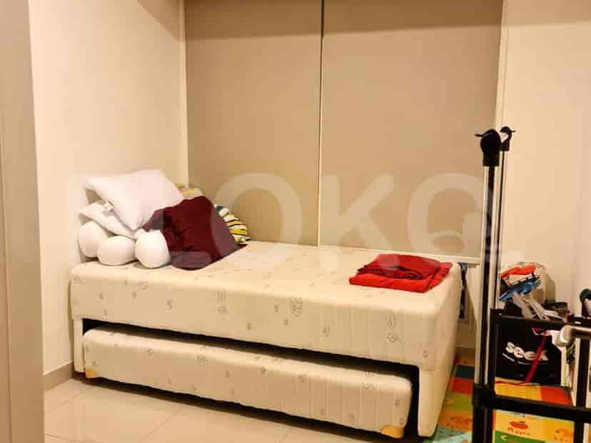 A room with a daybed, pull-out trundle, and storage.