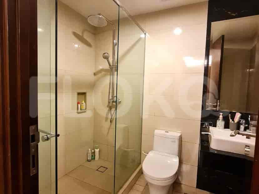 A modern bathroom with a walk-in shower, toilet, and sink.