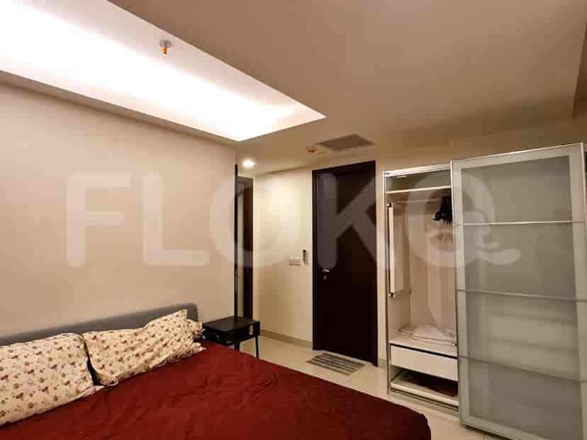 A master bedroom with a bed, wardrobe, and doors.