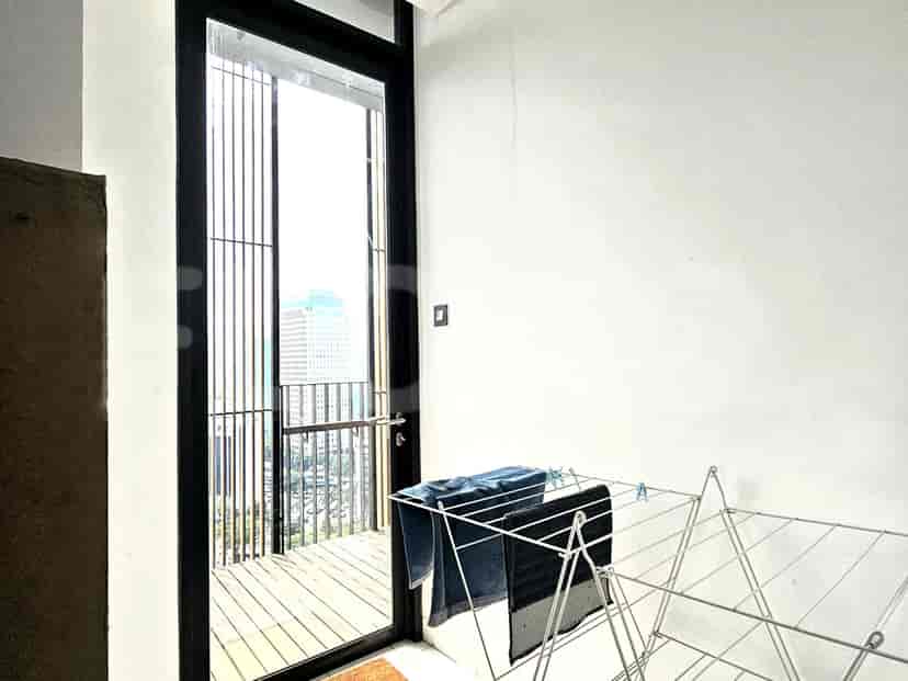 Balcony with a clothes drying rack.