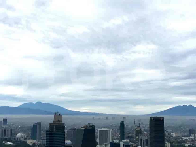 Panoramic view of a city skyline on an overcast day.