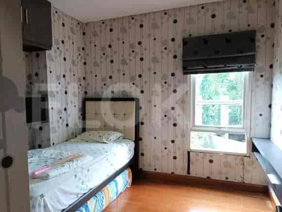 Bedroom with a single bed, wallpaper, and window.