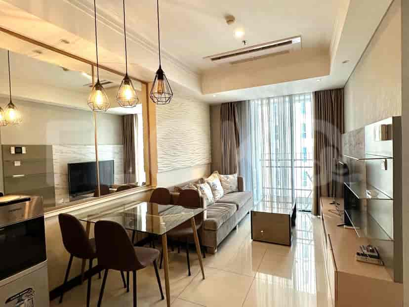 Living and dining area with glass table, pendant lights, and city view.