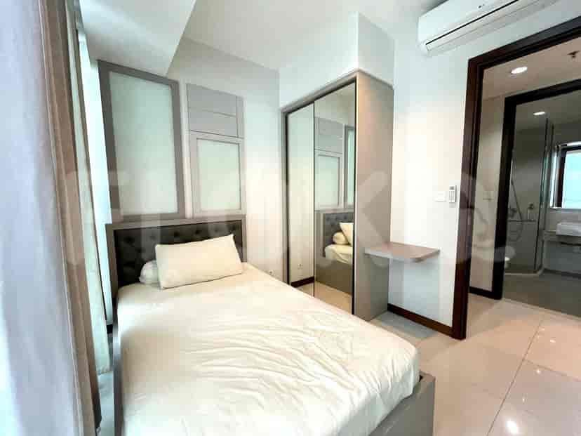 Modern bedroom with a single bed, mirrored closet, and a small desk.