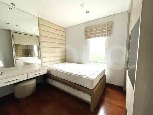 Bedroom with a single bed and a desk area next to the window.