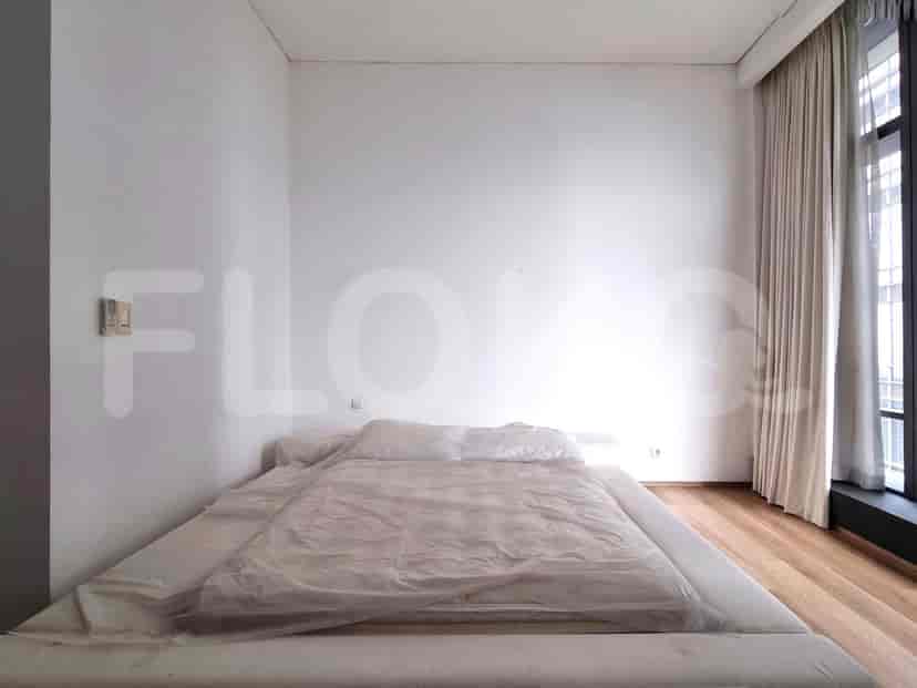Modern bedroom featuring a large bed and a minimalist aesthetic.