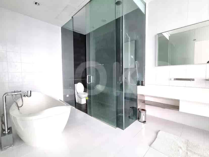 Luxurious bathroom with a bathtub, glass shower, and modern fixtures.