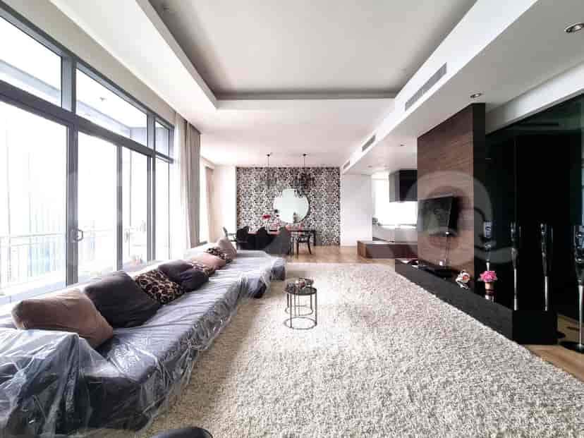 Spacious living room with a large sofa, rug, and stylish decor.