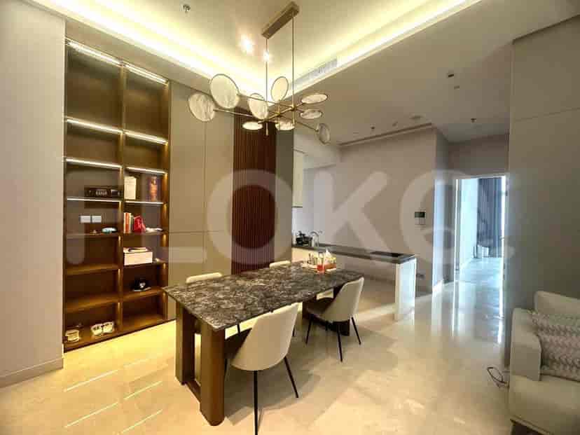 Dining area with a table, chairs, and shelving.