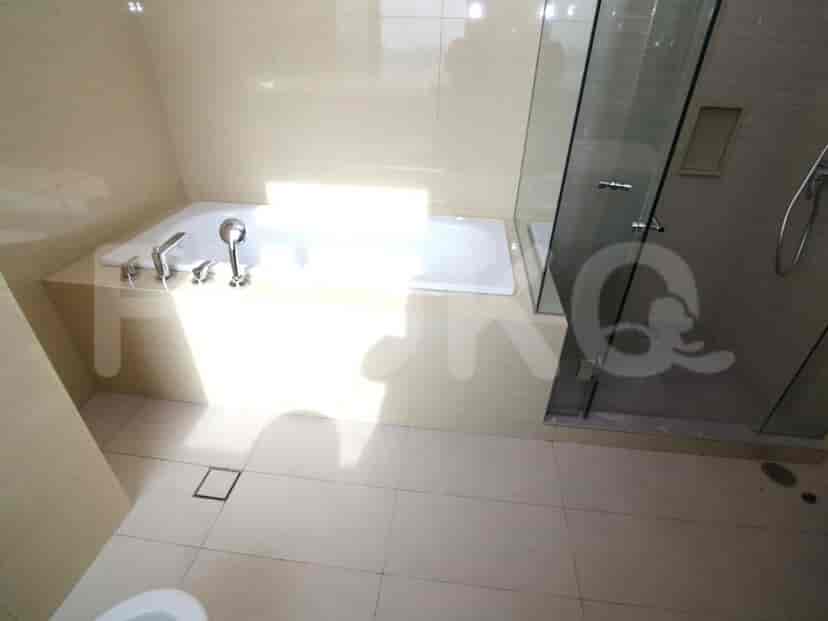 Bathroom with a bathtub and a separate glass-enclosed shower.