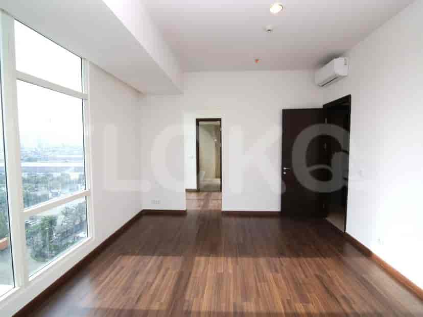 Living room with wooden flooring and a view of the cityscape.
