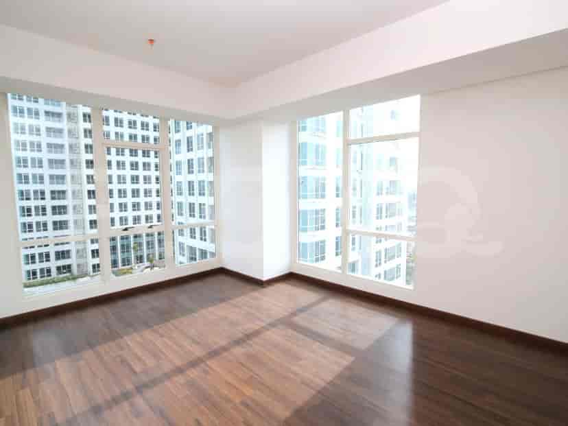Bedroom with expansive windows and wooden flooring.