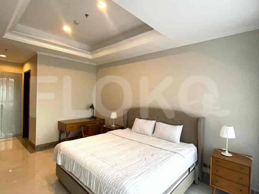 Kamar tidur dengan tempat tidur ganda, meja dan nakas.