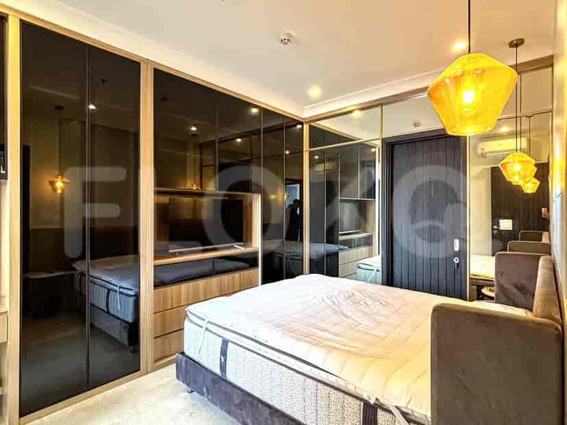A master bedroom with a king-sized bed, built-in closets, and a modern aesthetic.