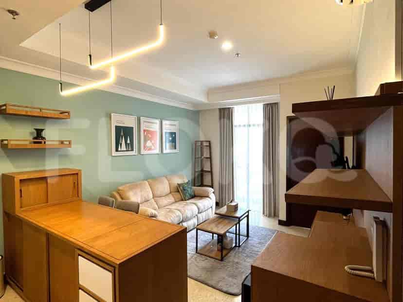Living room with sofa, coffee table, and decorative shelving.