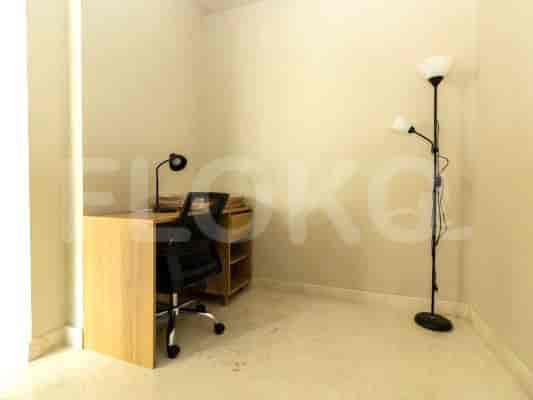 A well-lit study room with a desk, office chair, and a floor lamp.