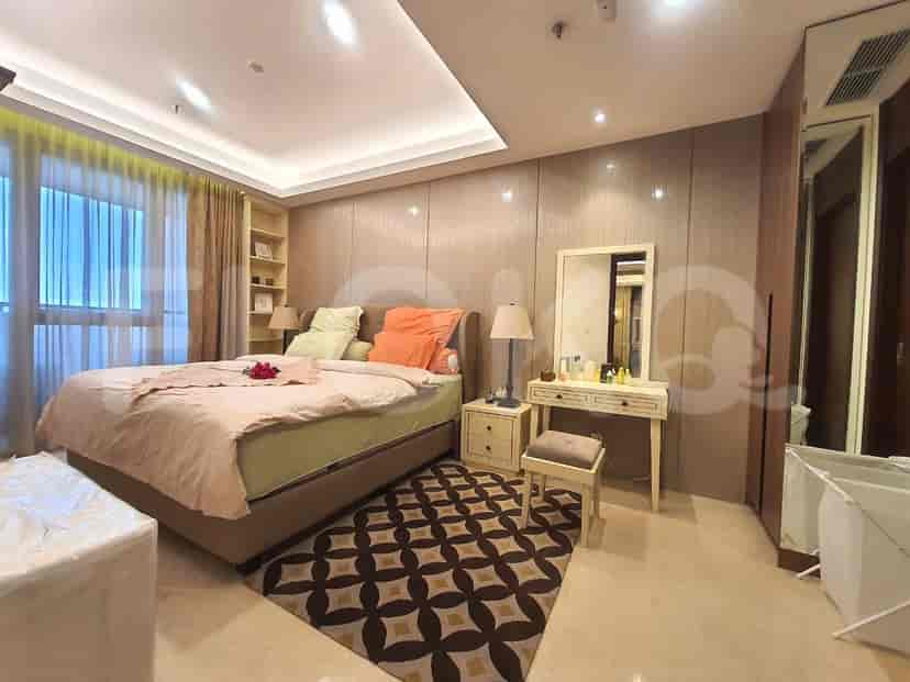 Bedroom with a double bed, dressing table and a wooden wardrobe.