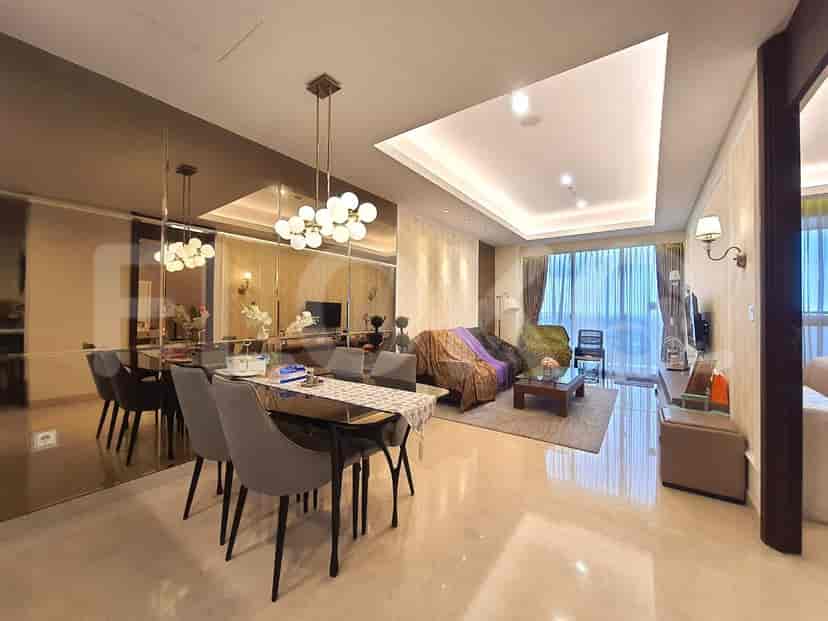 Living and dining area in a modern apartment with mirrored walls and stylish lighting.