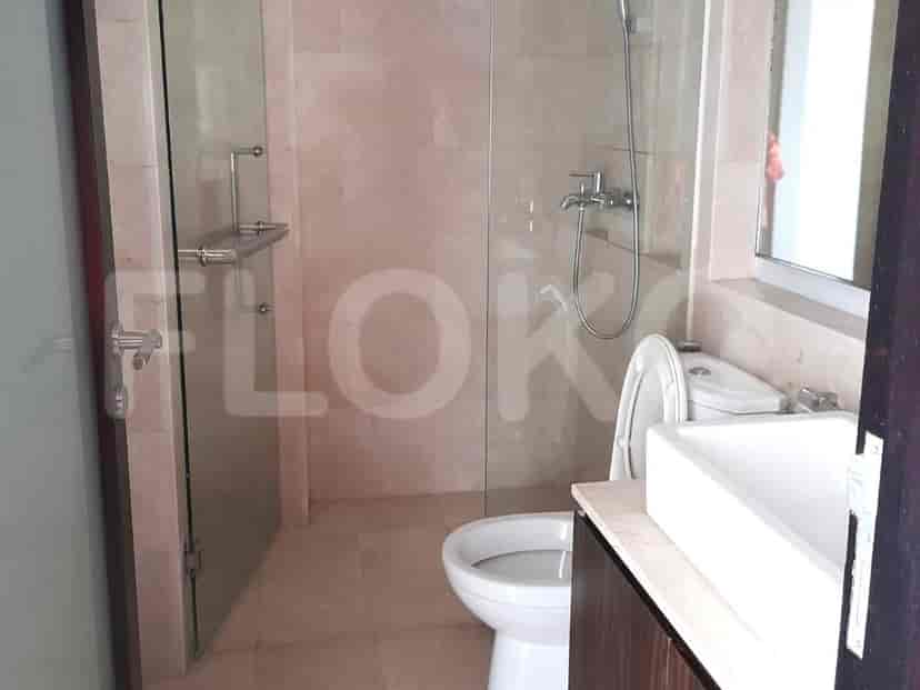 Modern bathroom with a glass shower enclosure and a toilet.
