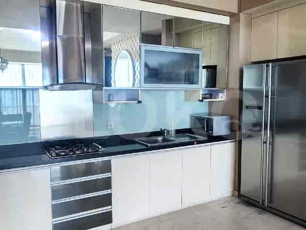 Modern kitchen with sleek cabinets, a refrigerator, and a microwave.