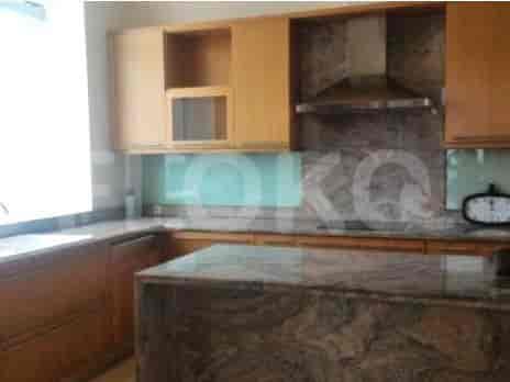 A modern kitchen with wooden cabinets, a kitchen island, and granite countertops.