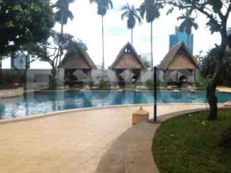 Outdoor swimming pool with cabanas.