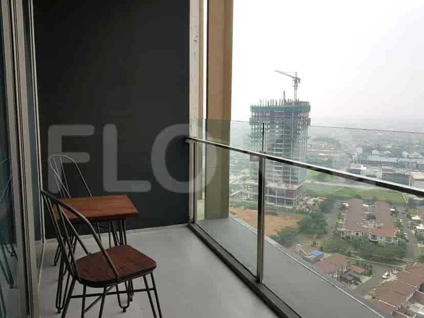 Outdoor balcony space with city views, featuring a small table and chairs.