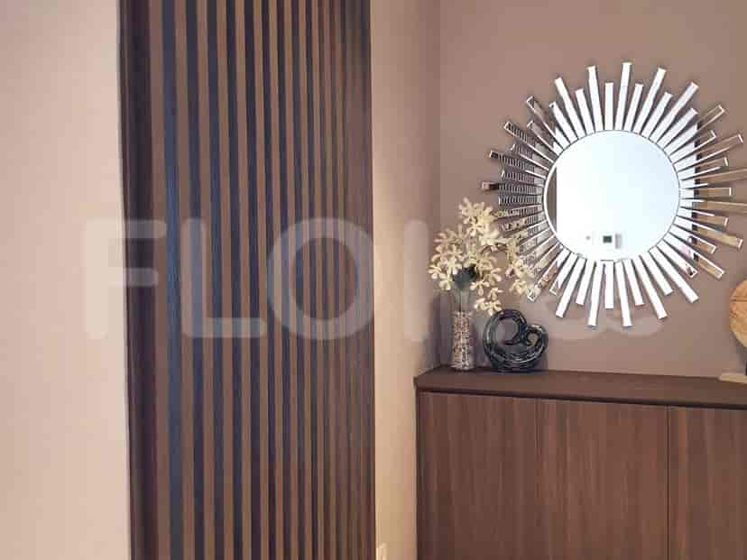 Entryway with a sunburst mirror and modern decor.