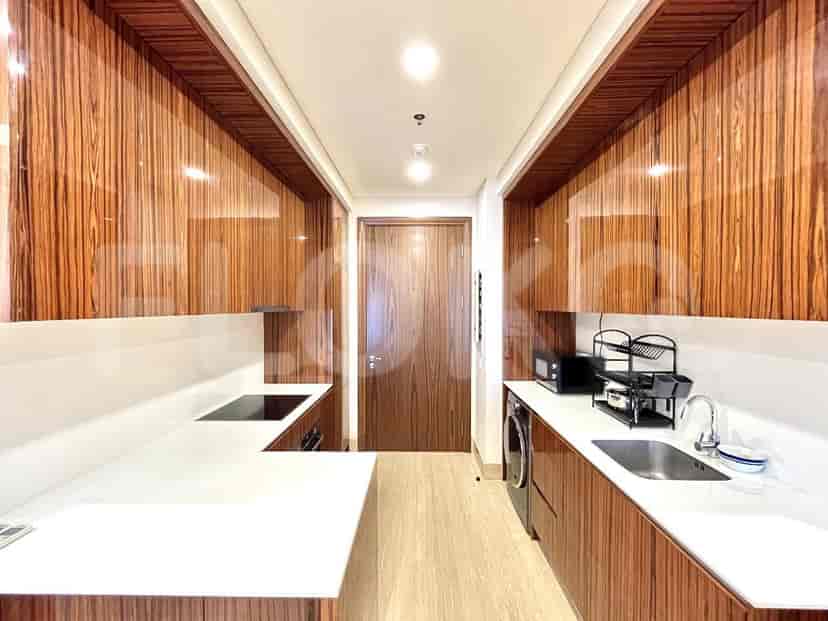 A modern kitchen with wooden cabinetry and appliances.