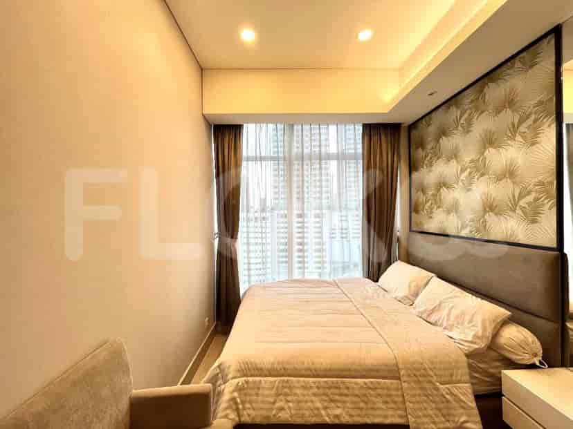 A bedroom with a queen bed, large windows, and modern design.