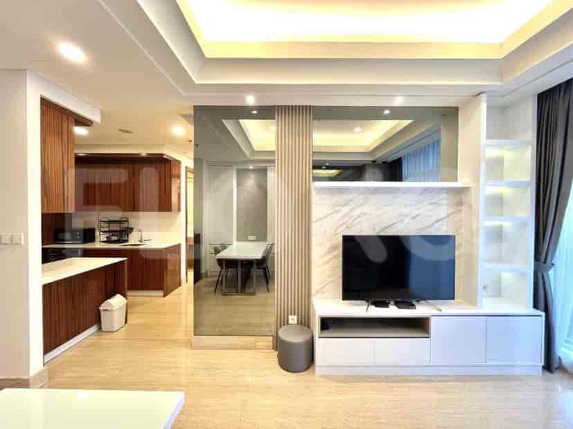 A modern living space featuring a dining area, kitchen, and TV unit.