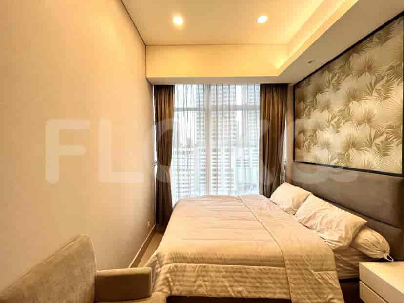 A bedroom with a bed, large windows, and a modern design.