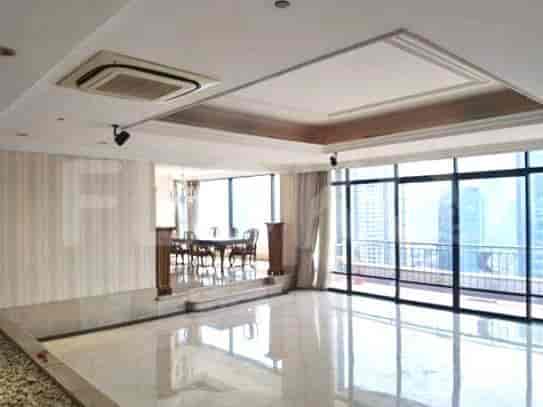 Spacious living area with marble flooring, large windows, and access to a balcony.
