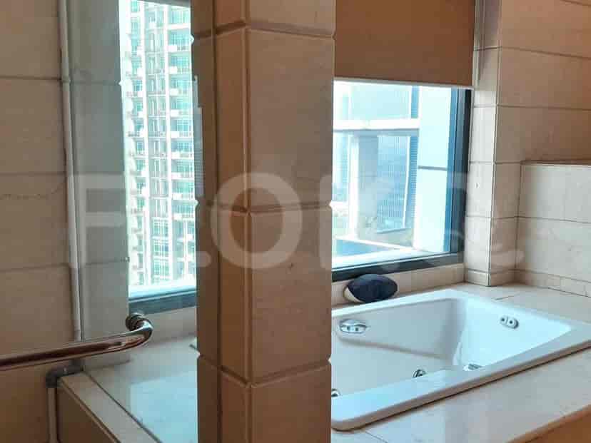 A luxurious bathroom featuring a bathtub, a large window and a shower area.