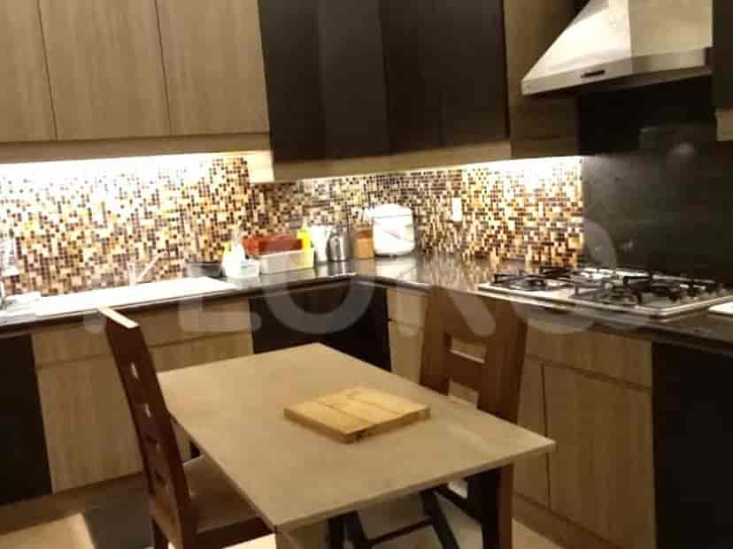 A well-equipped kitchen with wooden cabinetry, a gas stove, and a breakfast table.